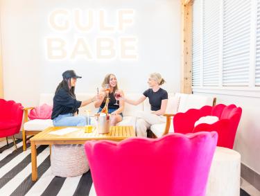 Friends enjoying drinks at Gulf Babe Wine Co. at The Wharf in Orange Beach